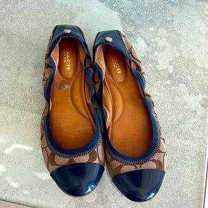 Coach flats with navy blue patent leather accents